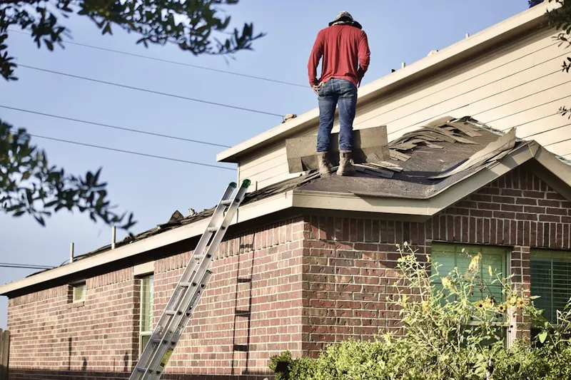 Professional roofer working on a residential roof in Knollwood
